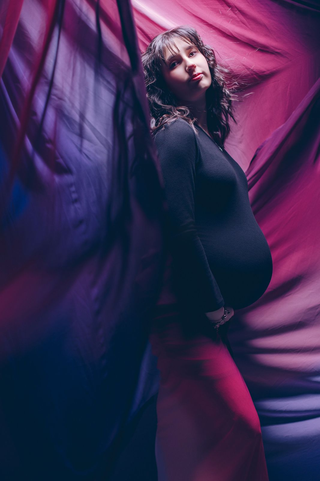 Maternity portrait among flowing fabric