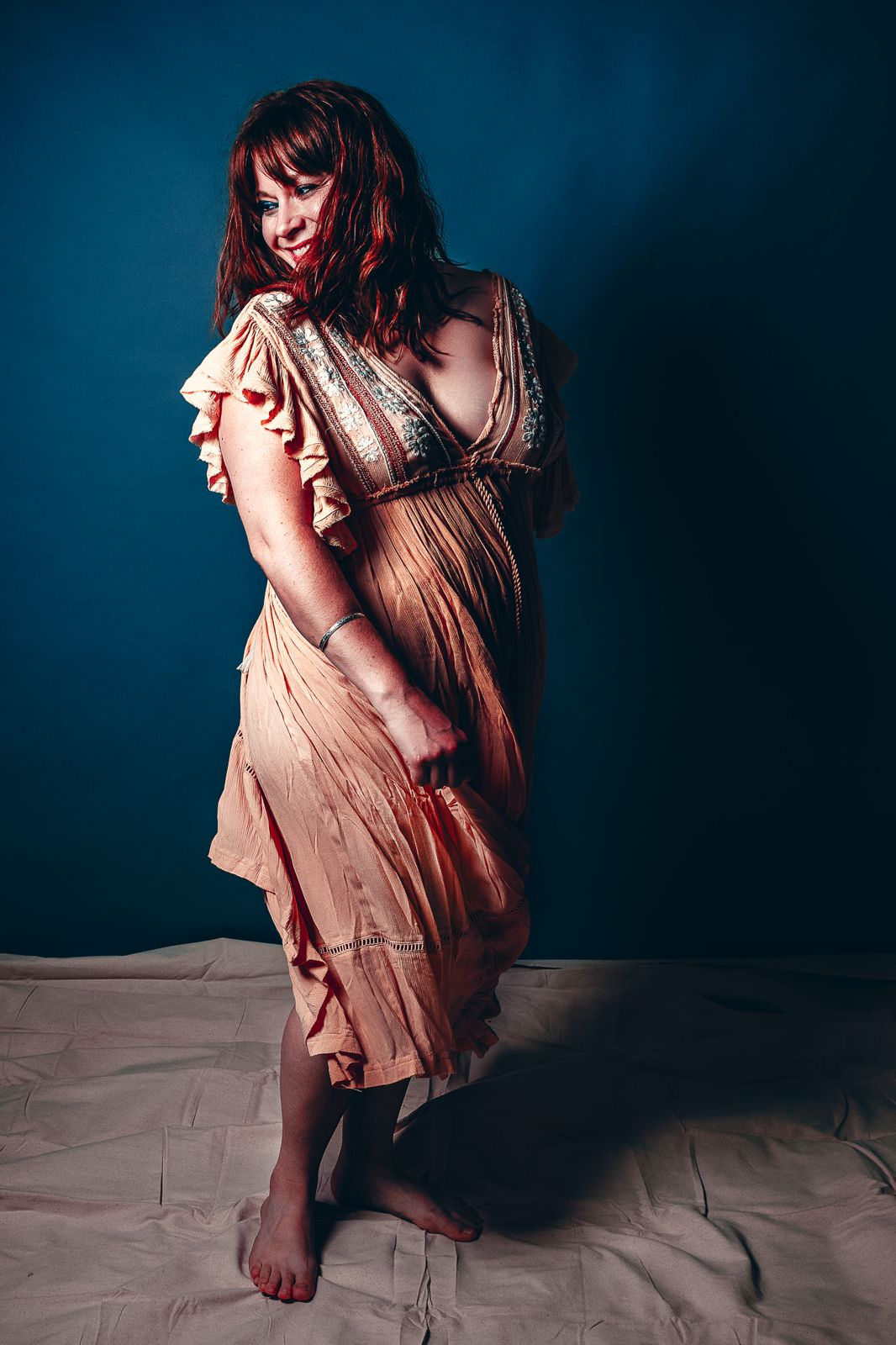 Laughing portrait in a peach dress