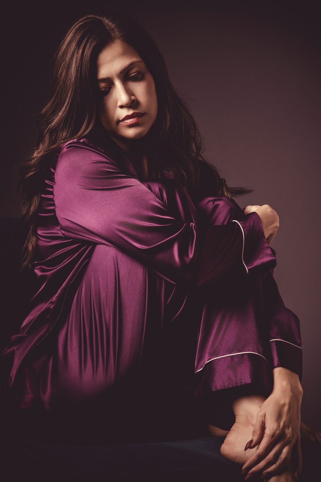 Seated portrait in plum satin