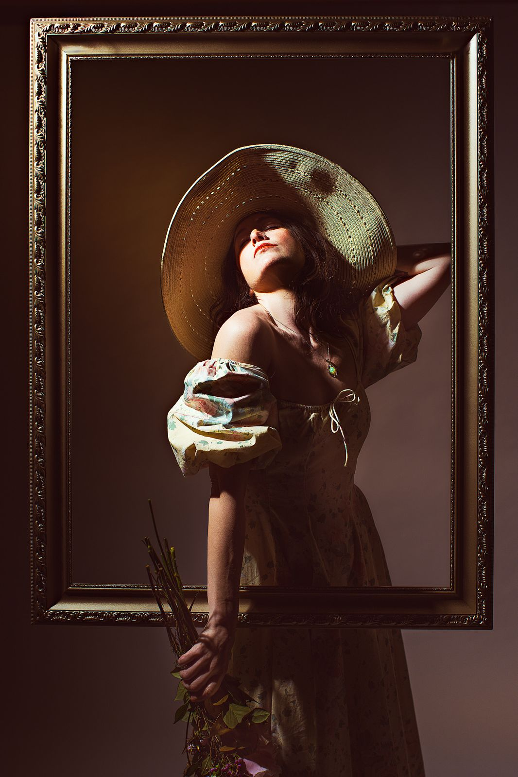 Portrait in a straw hat stepping out of a gilded frame